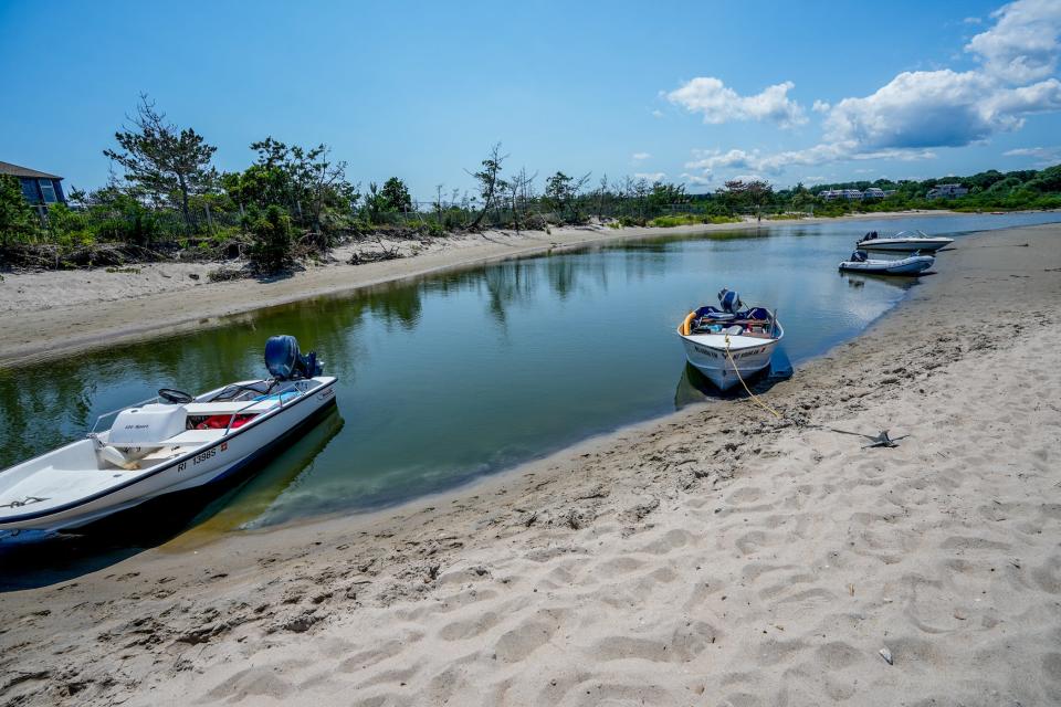 Boats anchor along Dog Island in the Narrow River.