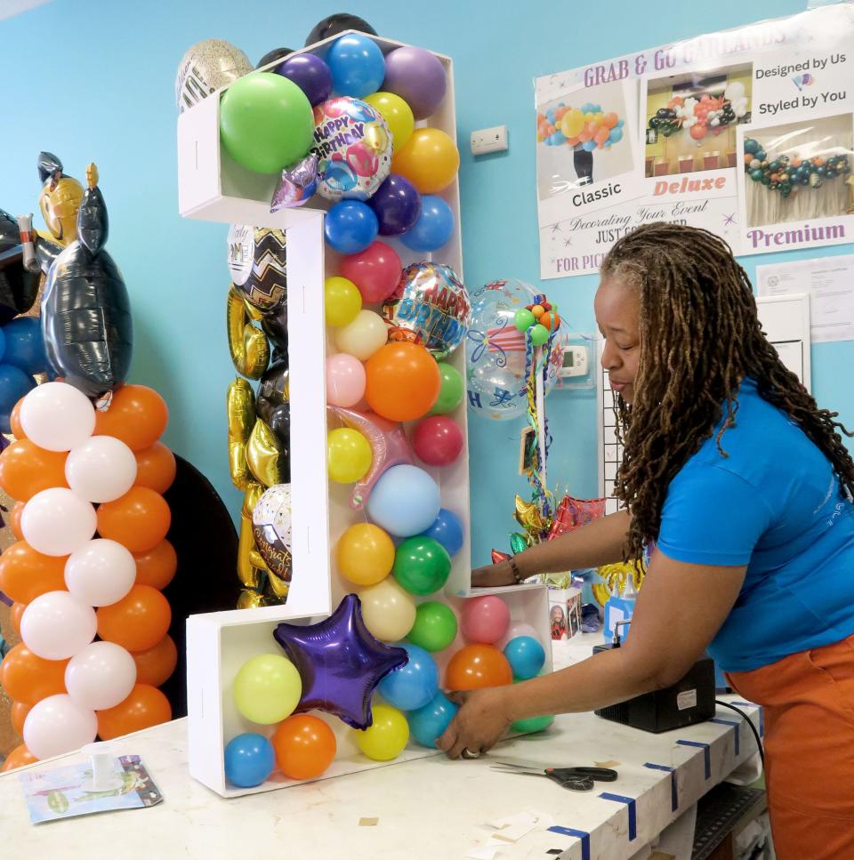 Celebration Creations owner Stephanie Cofield-Mixon arranges balloons inside a large number one for a birthday at the Stafford Township business Monday, May 20, 2024.