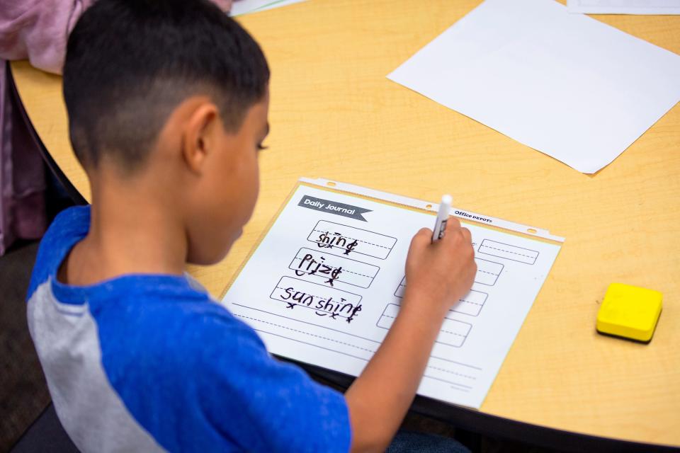 A third grade student writes during an intensive reading class at Freedom Elementary School in Buckeye on Nov. 16, 2021.