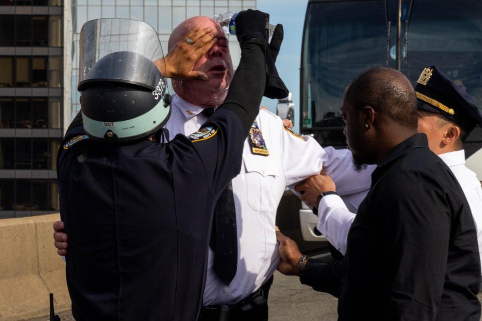 James McCarthy, NYPD assistant chief, is assisted after seemingly being affected by a chemical irritant as police arrest pro-Palestinian demonstrators blocking traffic on the Manhattan Bridge (Getty Images)