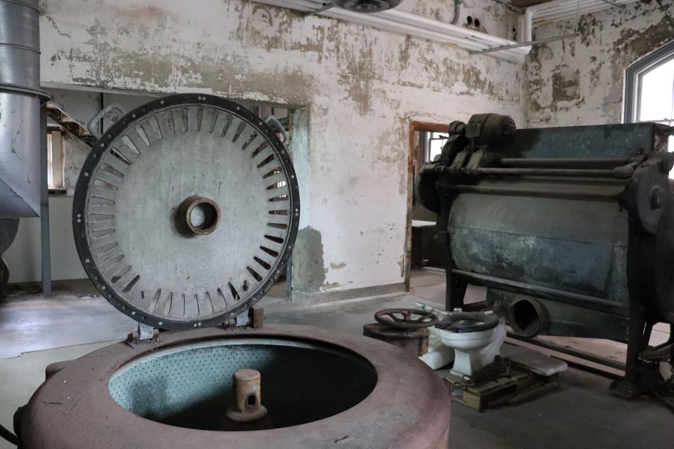 the abandoned ellis island laundry room with a rusted washer in the foreground