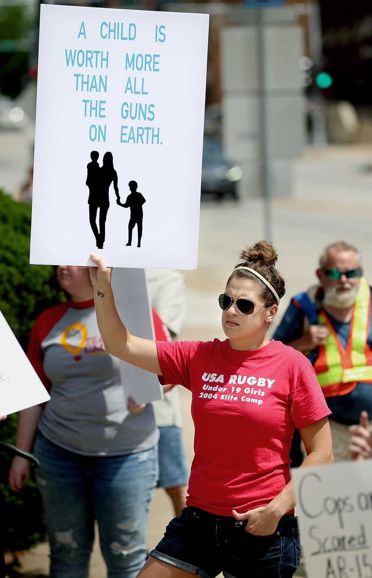 Karen Skinner of Springfield holds up a sign during the March for Our Lives Against Guns Violence rally in front of the state Capitol on Saturday, June 11, 2022.