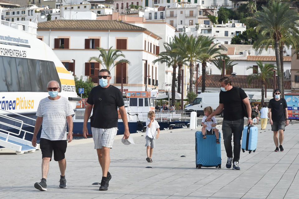 IBIZA, SPAIN - JULY 14:  People wearing face masks as a preventive measure are seen on July 14, 2020 in Ibiza, Spain. Since July 12, 2020 it is mandatory to wear a mask due to the increase in infections at the national and international level. (Photo by Stephane Cardinale - Corbis/Corbis via Getty Images,)