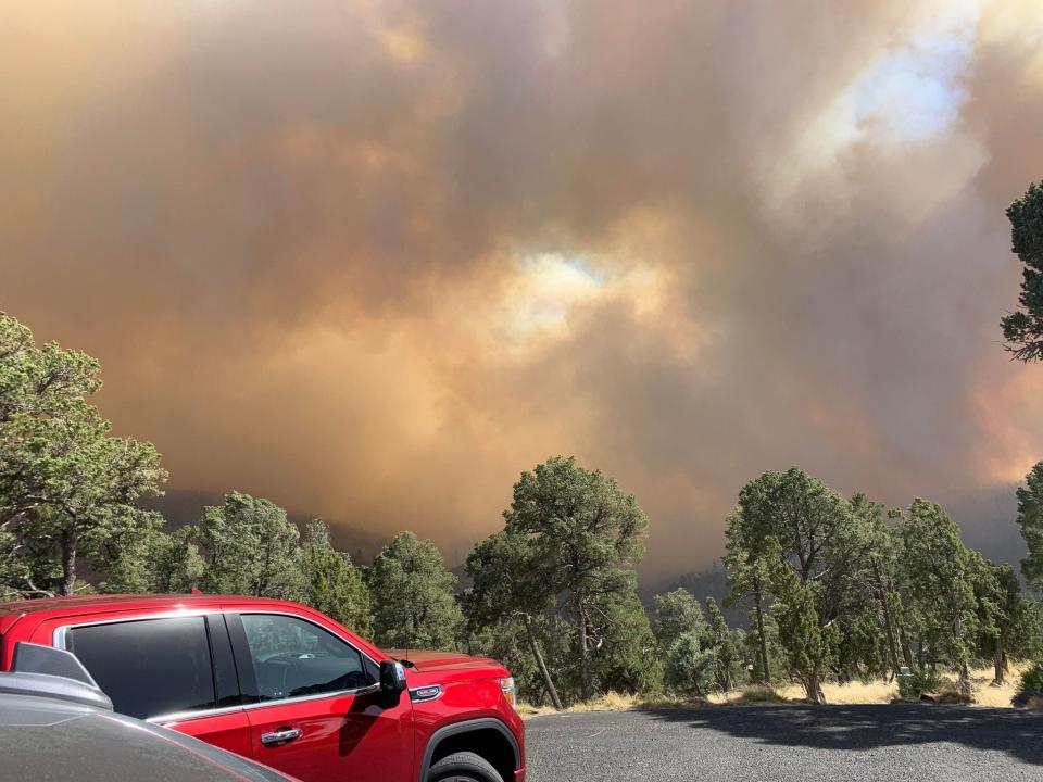 An Alto resident captures an image of wildfires burning in the Lincoln National Forest started April 12, 2022.