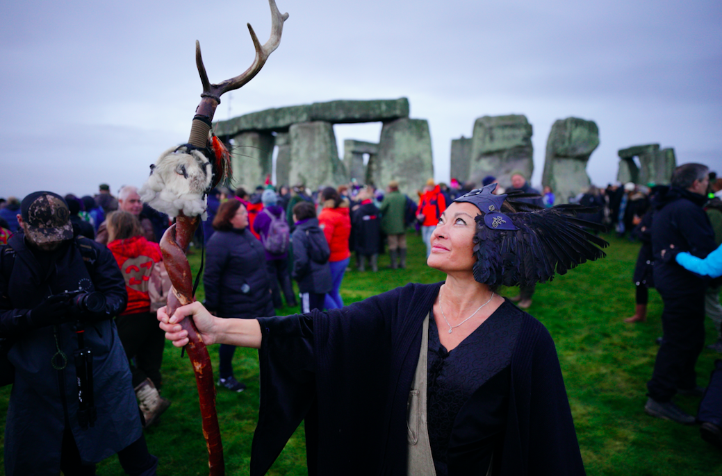 People take part in the winter solstice celebrations during sunrise at Stonehenge on Salisbury Plain in Wiltshire. (PA)