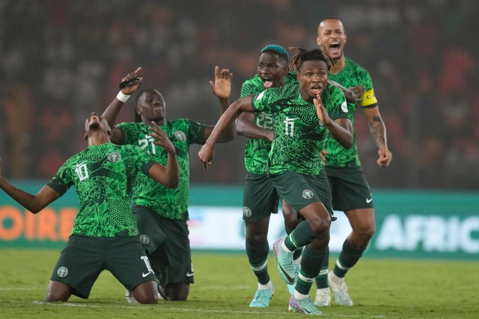 Nigeria's players celebrate winning the penalty shootout in the semifinal of the African Cup of Nations against South Africa at the Peace of Bouake stadium in Bouake Bouake, Ivory Coast.