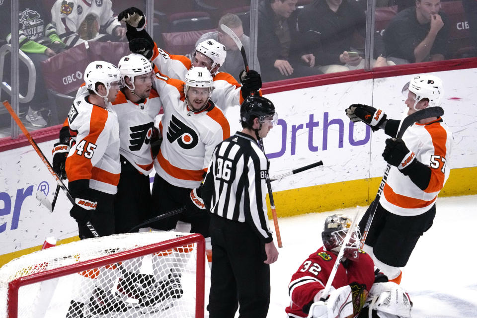 Philadelphia Flyers defenseman Ivan Provorov (9) celebrates with teammates after scoring against the Chicago Blackhawks in overtime of an NHL hockey game in Chicago, Thursday, April 13, 2023. The Flyers won 5-4. (AP Photo/Nam Y. Huh)