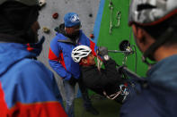 In this Friday, Jan. 17, 2020, photo, staff members of Asian Trekking, a Nepal-based mountaineering company, participate in a training session in Kathmandu, Nepal. Once relegated to support staff, Nepalese climbers famous for their skills on the world's highest peaks are emerging out of the shadows of their Western peers and now dominate the lucrative industry in the Himalayan nation. Sherpa guides are now more educated, and have traveled farther than their predecessors, picking up business acumen and corporate endorsements. As a result, there are more Nepal-based companies globally, not just in Nepal, but also in China, India and Pakistan, which collectively boast the world's 14 highest peaks. (AP Photo/Niranjan Shrestha)