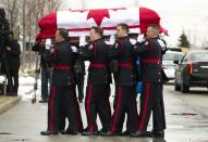 The casket of police constable John Zivcic is carried by honor guard into the public memorial in Toronto December 9, 2013. Zivcic died December 2, from injuries he sustained in a car crash while in pursuit of another vehicle. He was Toronto's 26th officer to die while on duty since the Toronto police force began in 1957. REUTERS/Fred Thornhill (CANADA - Tags: OBITUARY CRIME LAW)