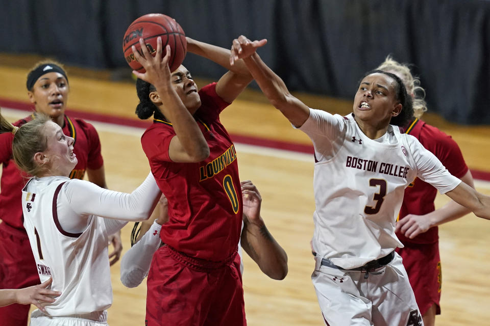 Louisville forward Ramani Parker (0) grabs an offensive rebound against Boston College guards Jaelyn Batts (3) and Cameron Swartz (1) in the second half of an NCAA college basketball game, Thursday, Feb. 4, 2021, in Boston. (AP Photo/Elise Amendola)