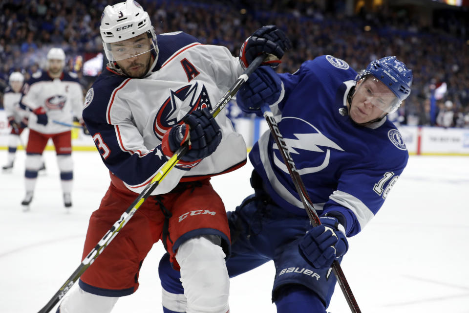 Columbus Blue Jackets defenseman Seth Jones (3) and Tampa Bay Lightning left wing Ondrej Palat (18) collide while chasing the puck during the second period of Game 1 of an NHL Eastern Conference first-round hockey playoff series Wednesday, April 10, 2019, in Tampa, Fla. (AP Photo/Chris O'Meara)