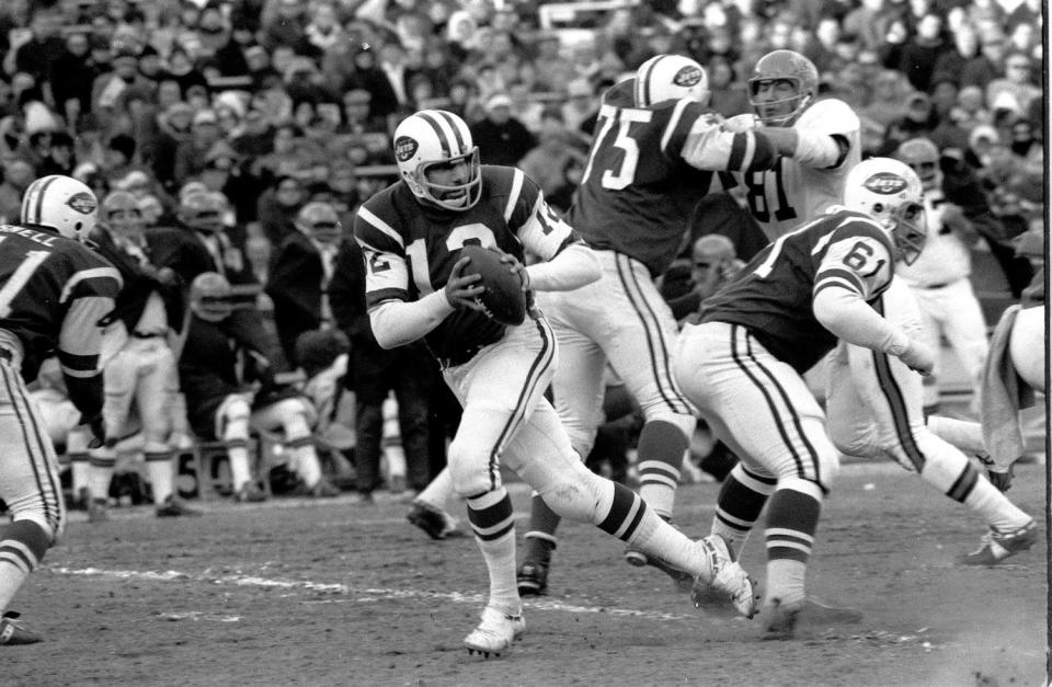 New York Jets quarterback Joe Namath fades back to pass against the Cincinnati Bengals at Shea Stadium in New York on Dec. 8, 1968.