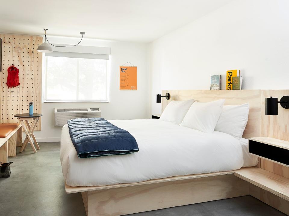 Inside a Field Station hotel room with a bed, furniture.