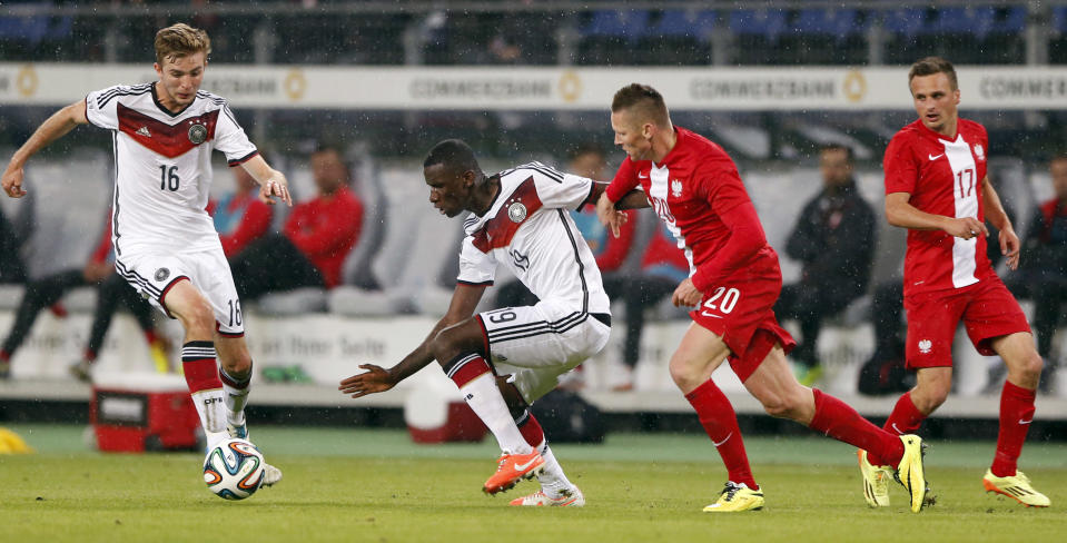 Germany's Christoph Kramer, from left, Germany's Antonio Ruediger and Poland's Marcin Robak challenge for the ball during a friendly soccer match between Germany and Poland in Hamburg, Germany, Tuesday, May 13, 2014. (AP Photo/Matthias Schrader)