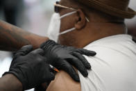 FILE - In this Feb. 10, 2021, file photo, a man receives a COVID-19 vaccine at the Martin Luther King Senior Center in North Las Vegas. The nation is poised to get a third vaccine against COVID-19, but health officials are concerned that at first glance the Johnson & Johnson shot may not be seen as equal to other options from Pfizer and Moderna. (AP Photo/John Locher, File)