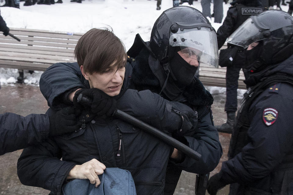 Police officers detain a man during a protest against the jailing of opposition leader Alexei Navalny in Moscow, Russia, Saturday, Jan. 23, 2021. Russian police on Saturday arrested hundreds of protesters who took to the streets in temperatures as low as minus-50 C (minus-58 F) to demand the release of Alexei Navalny, the country's top opposition figure. (AP Photo/Pavel Golovkin)