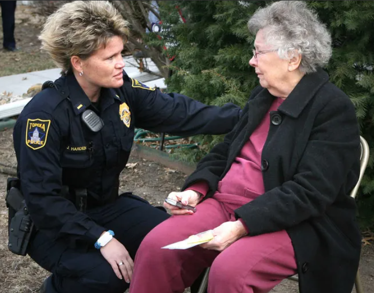 Topeka police Maj. Jana Harden, left, comforting a woman near the scene of a fatal explosion in 2012, is among three female police supervisors who are pursuing a gender discrimination lawsuit against Topeka's city government.