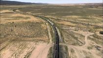 This Aug. 20, 2019, image shows a mile-long train leaving a coal silo near Kayenta, Ariz. en route to the Navajo Generating Station near Page. The electric train made its last delivery in late August as the coal-fired power plant prepared to close before the year ends. (AP Photo/Susan Montoya Bryan)