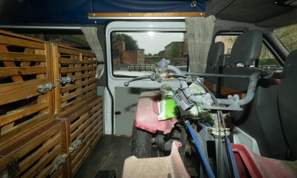 A quad bike and dog crates inside Vince King’s van.