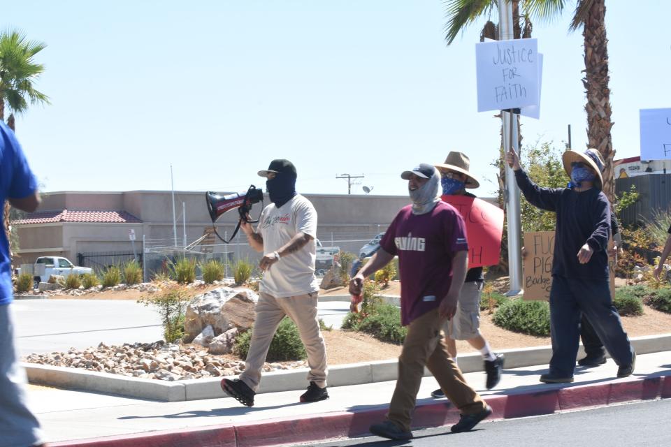 Los Angeles based activist Edin Enamorado, holding a megaphone, leads a protest in Victorville on Sunday, Sept. 24, 2023. The protest is in response to a 16-year-old girl being forcefully slammed to the ground by what appeared to be a uniformed San Bernardino County Sheriff's Department deputy at Victor Valley High School on Sept. 22, 2023.