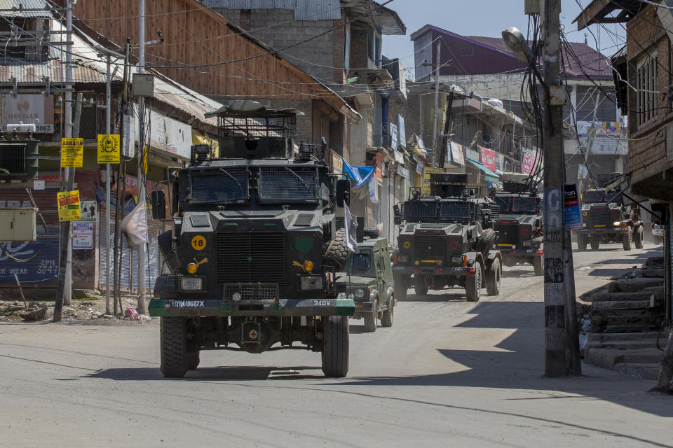 Indian army vehicles leave after the site of a gunbattle in Shopian, south of Srinagar, Indian controlled Kashmir, Friday, April 9, 2021. Seven suspected militants were killed and four soldiers wounded in two separate gunfights in Indian-controlled Kashmir, officials said Friday, triggering anti-India protests and clashes in the disputed region. (AP Photo/ Dar Yasin)