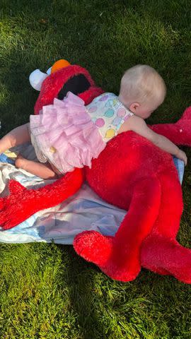 <p>Ireland Baldwin/Instagram</p> Ireland Baldwin's daughter Holland plays with a giant Elmo stuffed toy.