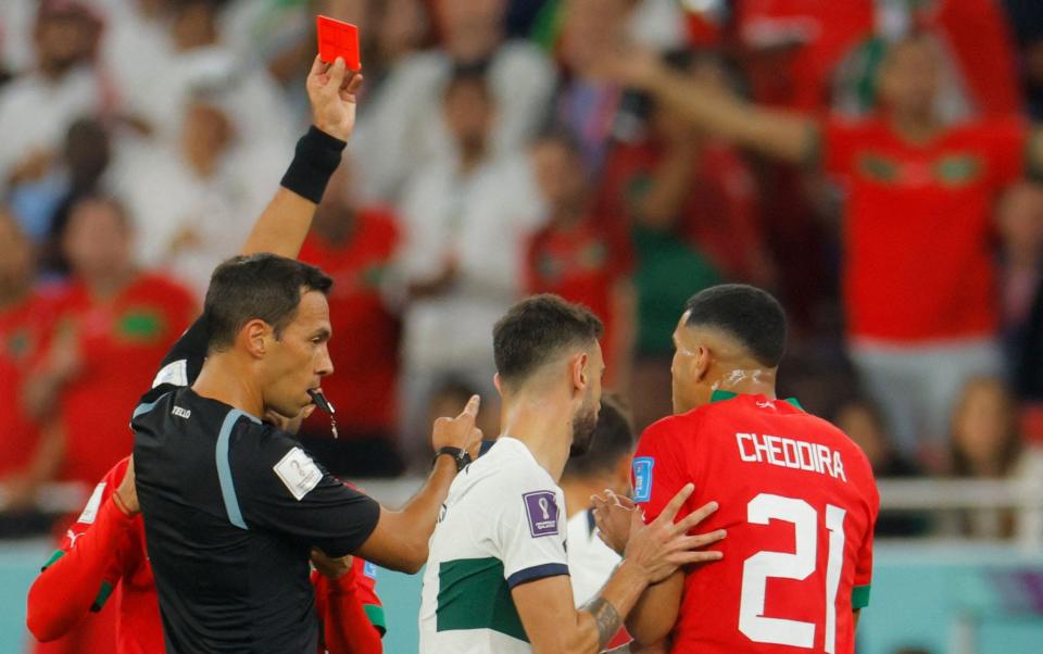 Argentina referee Facundo Tello (L) gives a red card to Morocco's midfielder #21 Walid Cheddira - AFP