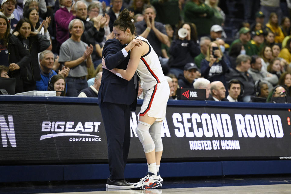 UConn head coach Geno Auriemma, left, embraces player Lou Lopez Senechal in the second half of a second-round college basketball game against Baylor in the NCAA Tournament, Monday, March 20, 2023, in Storrs, Conn. (AP Photo/Jessica Hill)