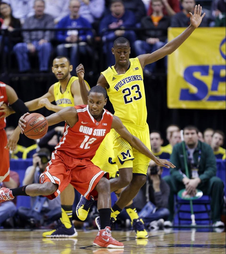 Ohio State forward Sam Thompson (12) drives against Michigan guard Caris LeVert (23) in the first half of an NCAA college basketball game in the semifinals of the Big Ten Conference tournament Saturday, March 15, 2014, in Indianapolis. (AP Photo/Michael Conroy)