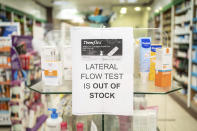 A sign saying lateral flow coronavirus tests are out of stock is displayed in a pharmacy window in London, Thursday Dec. 30, 2021. Officials have warned revellers in Scotland and Wales to think twice before travelling to England to ring in the new year, highlighting how the four parts of the U.K. were again taking starkly different approaches to coronavirus restrictions amid record-high infections and soaring hospitalizations. Prime Minister Boris Johnson has resisted tightening restrictions in England despite the rapid spread of the highly transmissible omicron variant. (Dominic Lipinski/PA via AP)