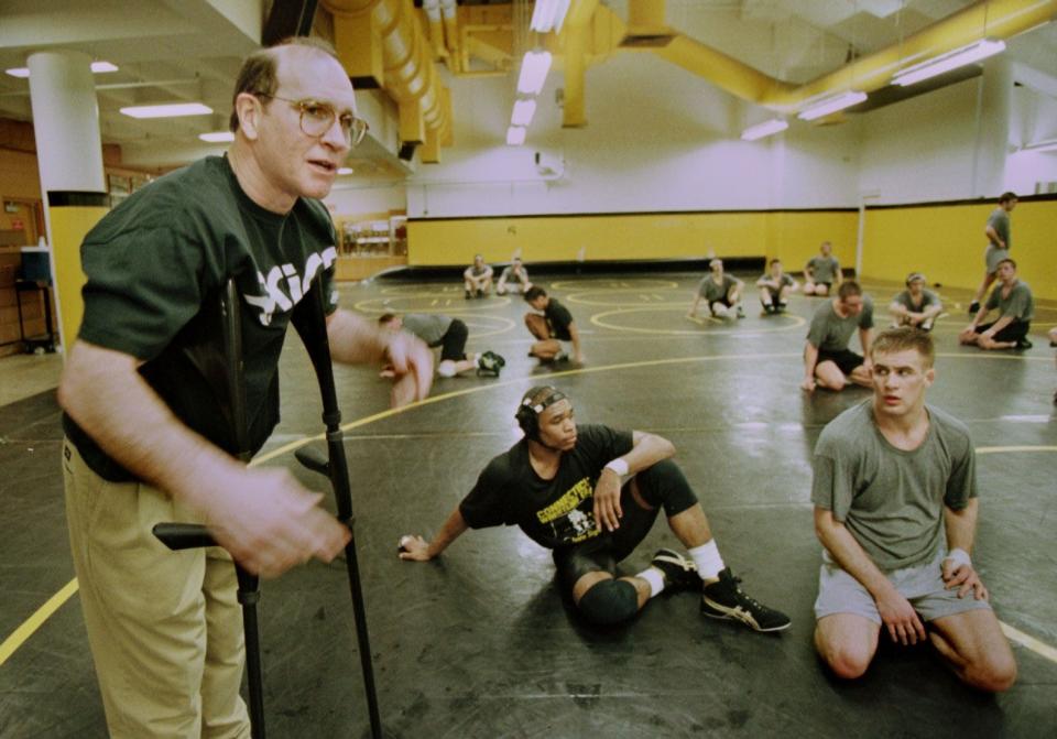 1997: Dan Gable, left, instructs his wrestlers at the University of Iowa, among them Joe Williams, center, and Justin Decker.