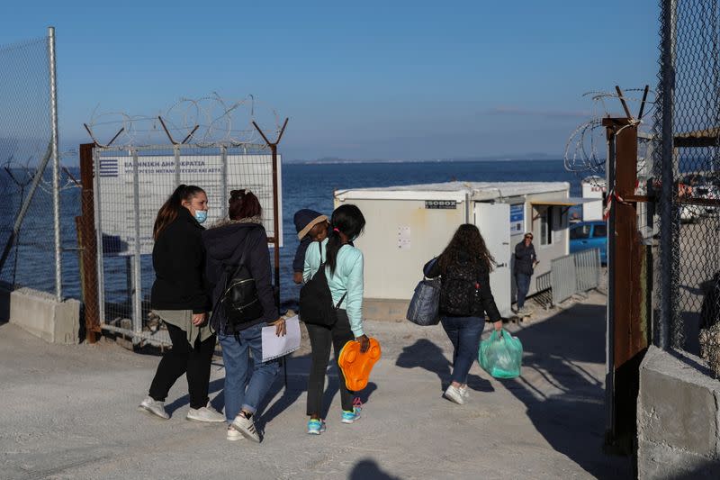 Migrants enter the Mavrovouni camp on the island of Lesbos