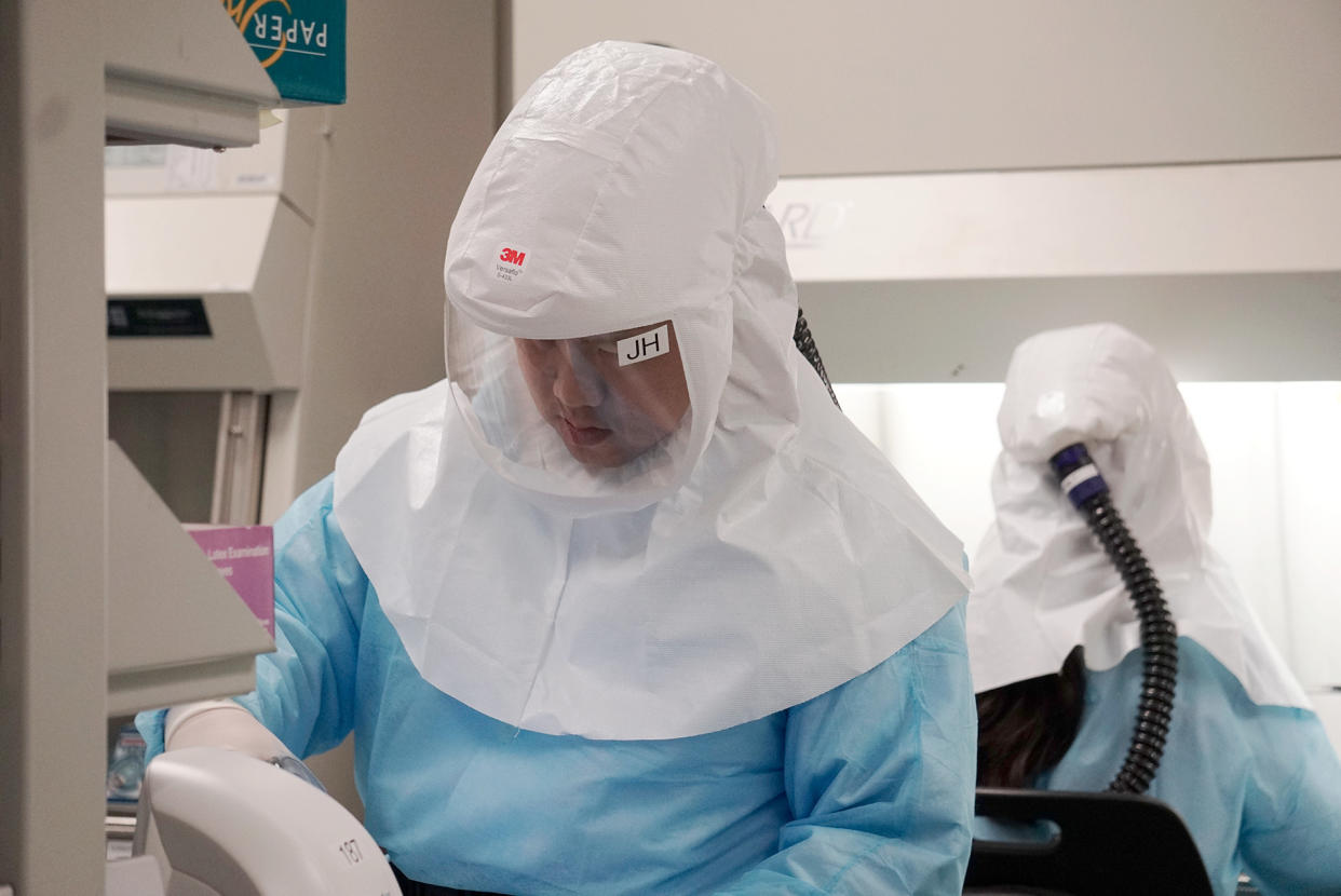 Home Team Science and Technology Agency (HTX) scientists demonstrating how the new COVID-19 test kit is used to detect the virus on 5 March 2020. (PHOTO: Dhany Osman / Yahoo News Singapore)