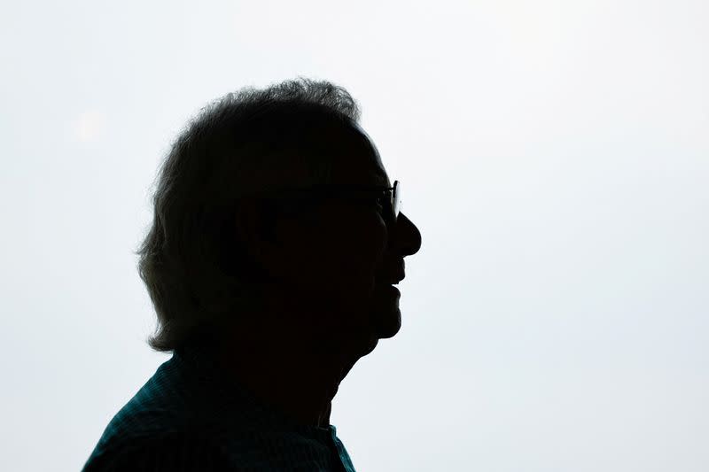 Bangladeshi Nobel peace prize winner Dr. Muhammad Yunus is silhouetted as he poses for a picture during an interview with Reuters in his office, in Dhaka
