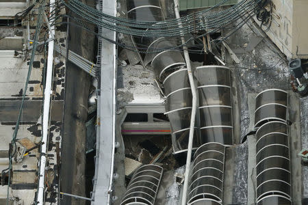 A derailed New Jersey Transit train is seen under a collapsed roof after it derailed and crashed into the station in Hoboken, New Jersey. REUTERS/Carlo Allegri