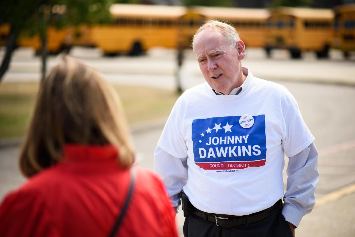 District 5 council member Johnny Dawkins speaks to a voter at Max Abbott Middle School on Tuesday, Oct. 10, 2023.