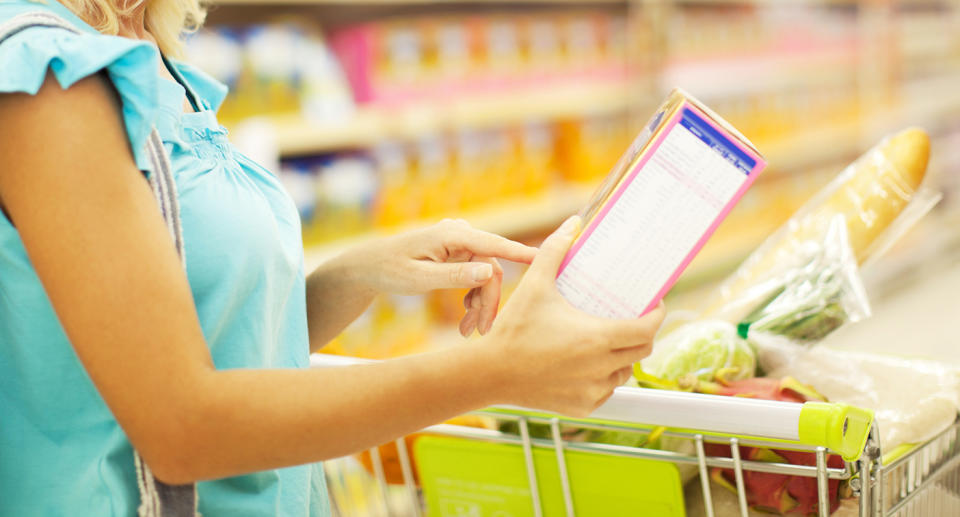 Woman shopping for cereal.