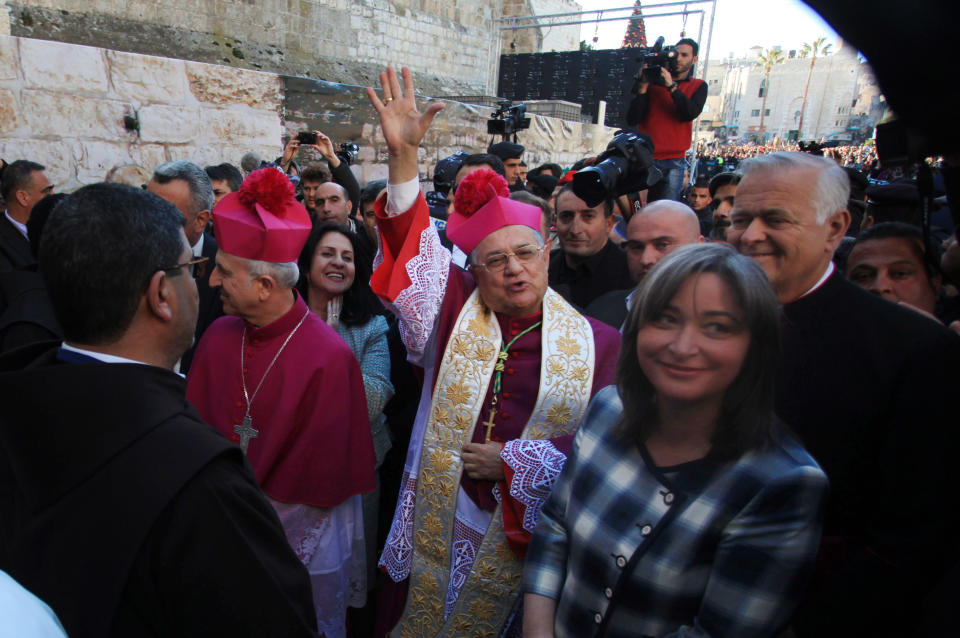 Latin Patriarch of Jerusalem Fouad Twal, center, arrives to the Church of the Nativity, traditionally believed by Christians to be the birthplace of Jesus Christ on the Christmas Eve in the West Bank town of Bethlehem, Tuesday, Dec. 24, 2013. (AP Photo/Majdi Mohammed)