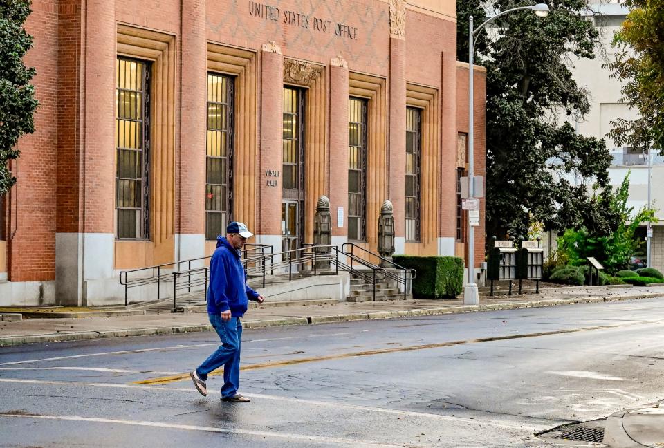 Most pedestrians seemed unfazed Tuesday, November 1, 2022 by the brief rain in Downtown Visalia. 