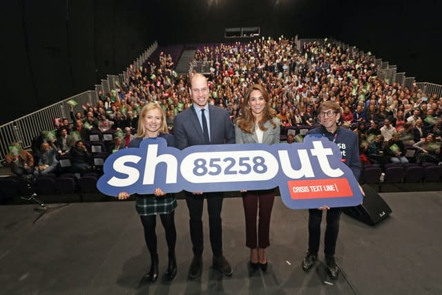 William and Kate on a London theatre stage during a volunteer celebration event with the text helpline Shout. Yui Mok/PA 