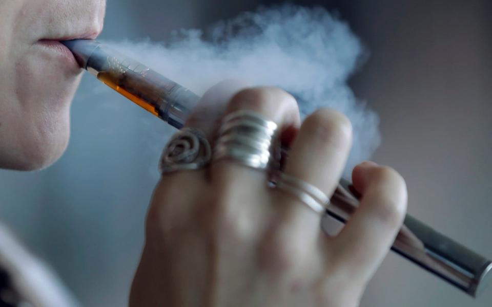 Smoking is thought to increase the risk of coronavirus infection as your hand is often close to - or touching - your face - Tony Dejak/AP