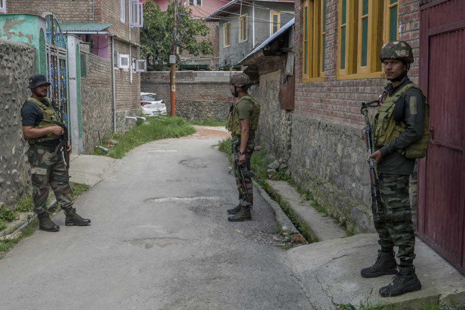 Indian army soldiers stand guard outside the house of their colleague Waseem Sarvar Bhat, who was killed in a gunfight with suspected rebels, in Bandipora, north of Srinagar, Indian controlled Kashmir, Saturday, Aug. 5, 2023. Three Indian soldiers were killed in a gunbattle with rebels fighting against New Delhi's rule in Kashmir, officials said Saturday, as authorities stepped up security on the fourth anniversary since India revoked the disputed region's special status. (AP Photo/Dar Yasin)