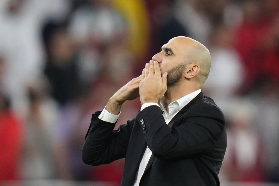 Morocco's head coach Walid Regragui celebrates winning the World Cup quarterfinal soccer match against Portugal, at Al Thumama Stadium in Doha, Qatar, Saturday, Dec. 10, 2022. (AP Photo/Petr David Josek)