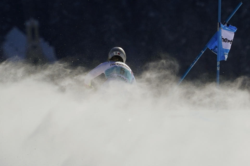 Switzerland's Corinne Suter speeds down the course during an alpine ski an alpine ski, women's World Cup super-G in St. Moritz, Switzerland, Sunday, Dec. 12, 2021. (AP Photo/Marco Tacca)