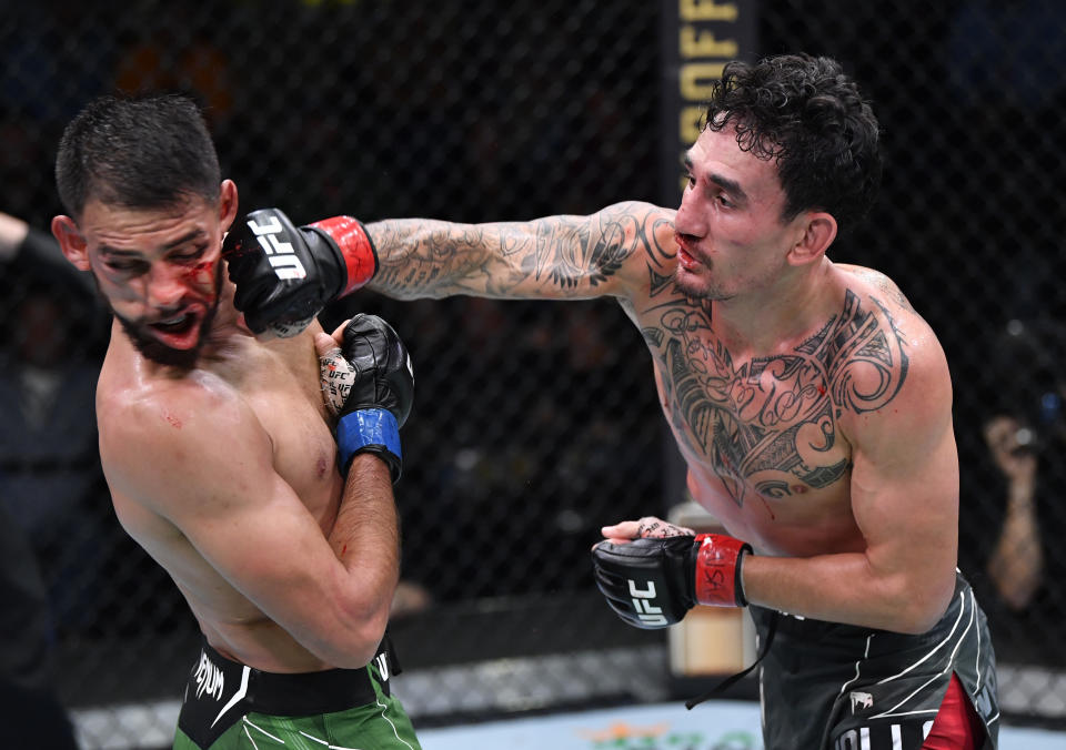 LAS VEGAS, NEVADA - NOVEMBER 13: (R-L) Max Holloway punches Yair Rodriguez of Mexico in a featherweight fight during the UFC Fight Night event at UFC APEX on November 13, 2021 in Las Vegas, Nevada. (Photo by Chris Unger/Zuffa LLC)