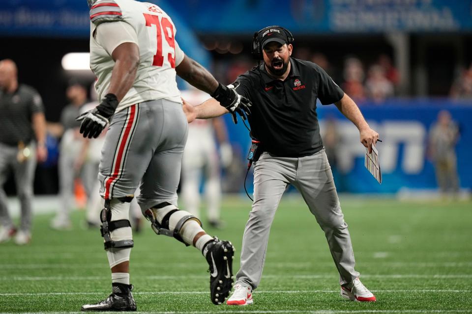 Ohio State Buckeyes head coach Ryan Day high fives offensive lineman Dawand Jones (79) during the second half of the Peach Bowl in the College Football Playoff semifinal, Dec 31, 2022, in Atlanta. Georgia won 42-41.