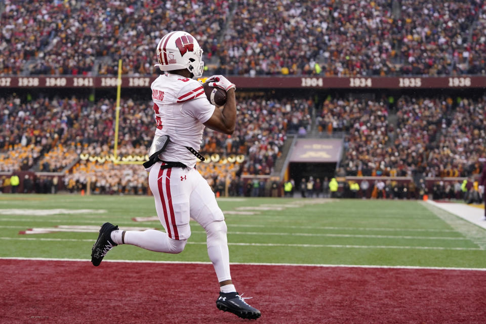 Wisconsin wide receiver Will Pauling (6) catches an 11-yard touchdown pass during the first half of an NCAA college football game against Minnesota, Saturday, Nov. 25, 2023, in Minneapolis. (AP Photo/Abbie Parr)