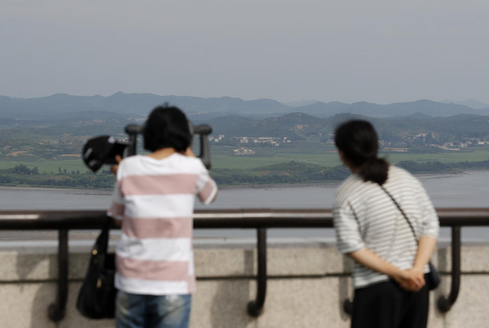 Visitors use binoculars to see the North Korean side from the unification observatory in Paju, South Korea, Sunday, Aug. 11, 2019. North Korea said Sunday leader Kim Jong Un supervised test-firings of an unspecified new weapons system, which extended a streak of launches that are seen as an attempt to build leverage ahead of negotiations with the United States while driving a wedge between Washington and Seoul. (AP Photo/Lee Jin-man)