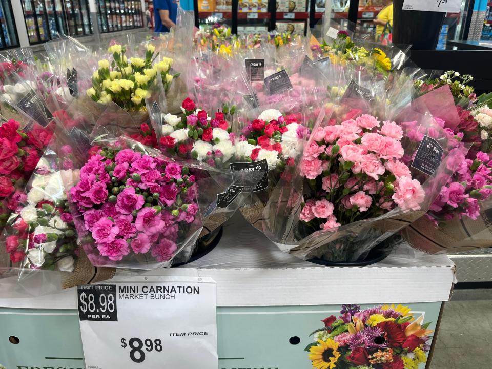 Display of cellophane-wrapped bouquets of flowers at Sam's Club