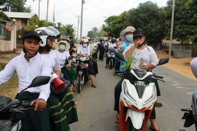 People take part in a motorcycle parade during a protest against the military coup, in Launglon township